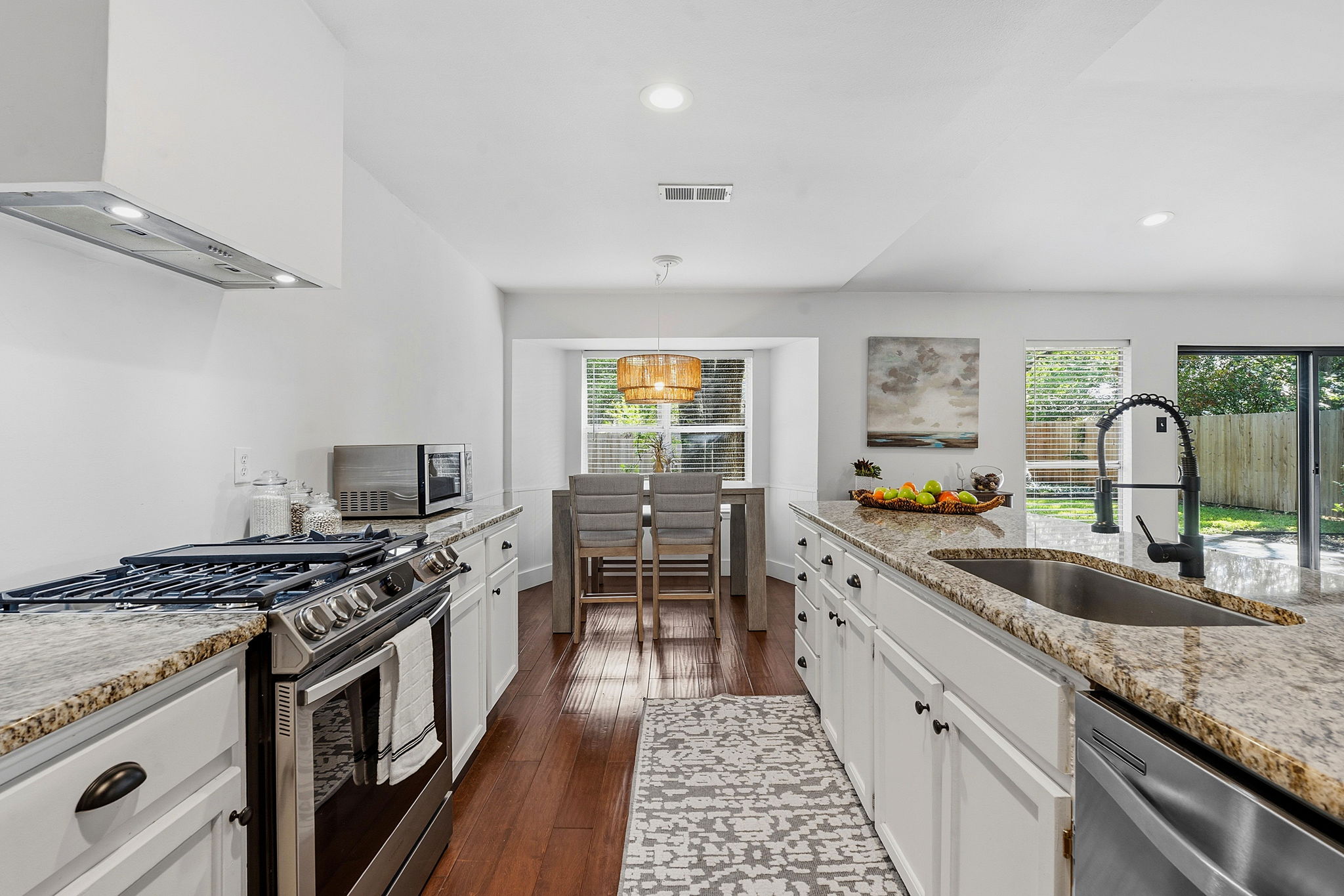 4705 Fieldstone Drive Austin, TX 78735 - Photo 10 of 34 a kitchen with granite countertop a stove and a sink