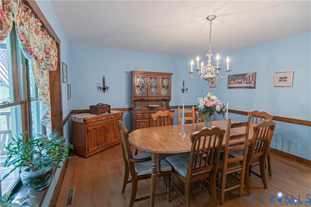 19321 River Road Chesterfield, VA 23838 - Photo 20 of 50 a view of a dining room with furniture a chandelier and wooden floor