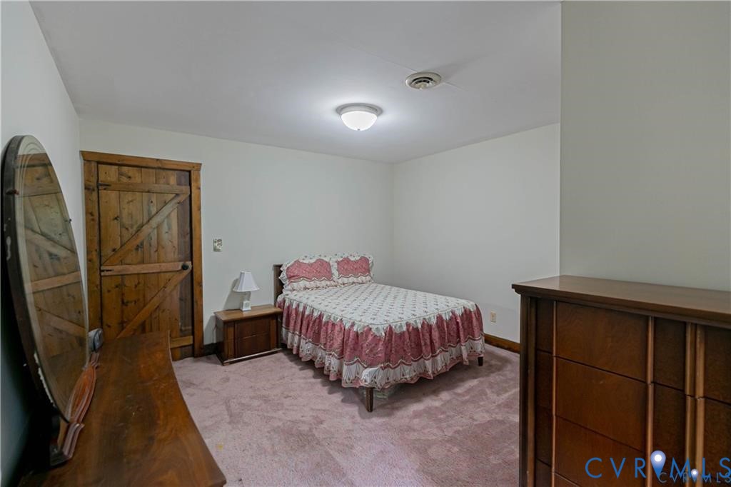 19321 River Road Chesterfield, VA 23838 - Photo 45 of 50 a bedroom with a bed and wooden floor