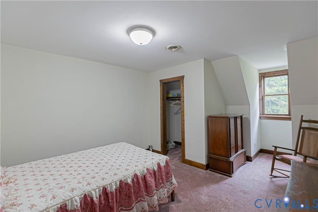 19321 River Road Chesterfield, VA 23838 - Photo 47 of 50 a bedroom with a bed and a refrigerator