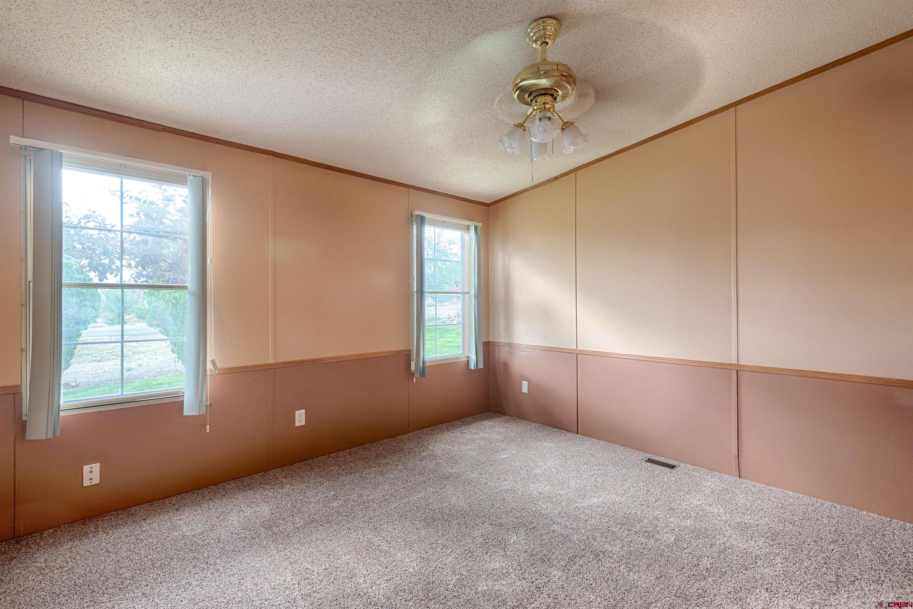 67135 N Road Montrose, CO 81401 - Photo 14 of 35 an empty room with windows and closet