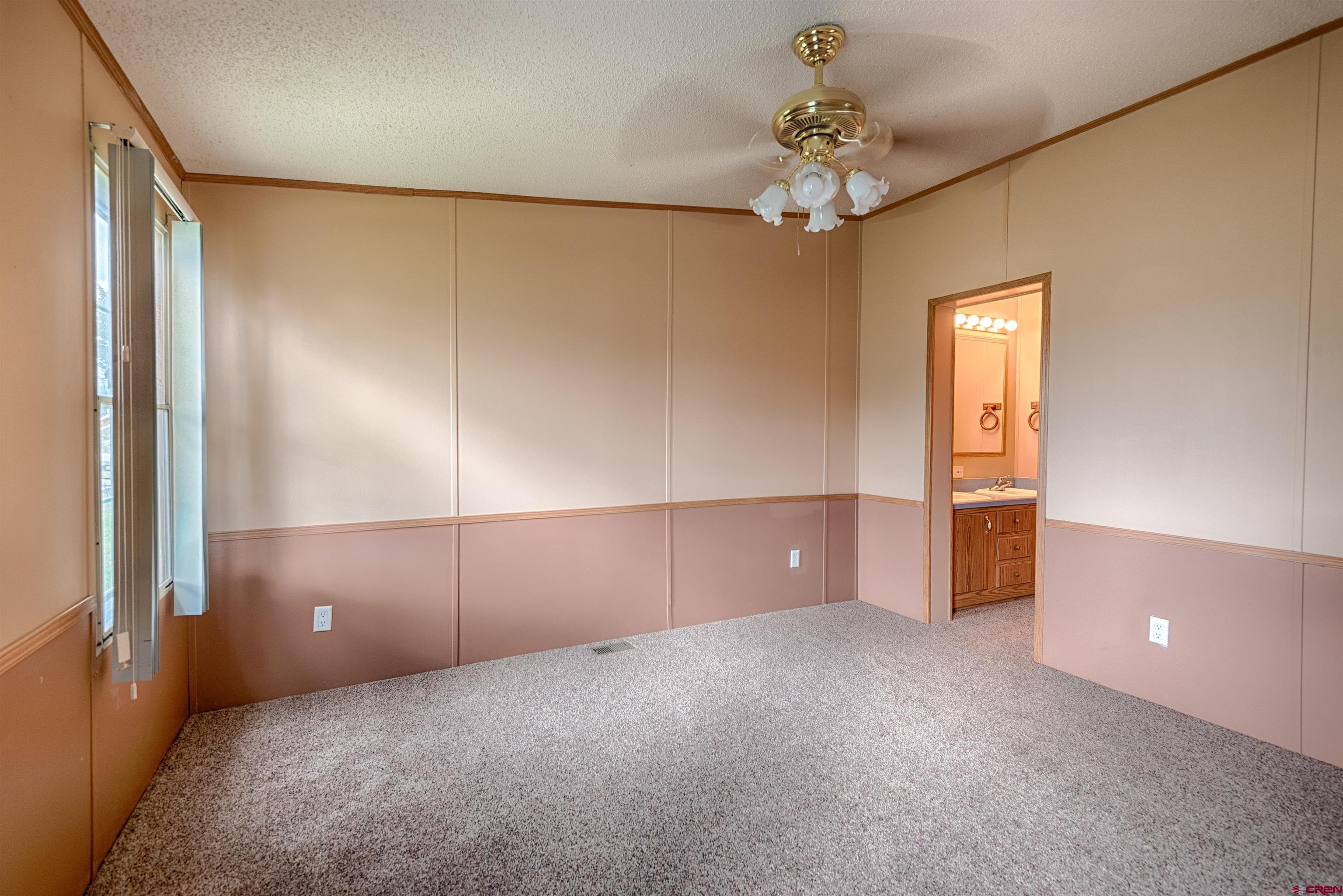 67135 N Road Montrose, CO 81401 - Photo 15 of 35 an empty room with windows and entrance