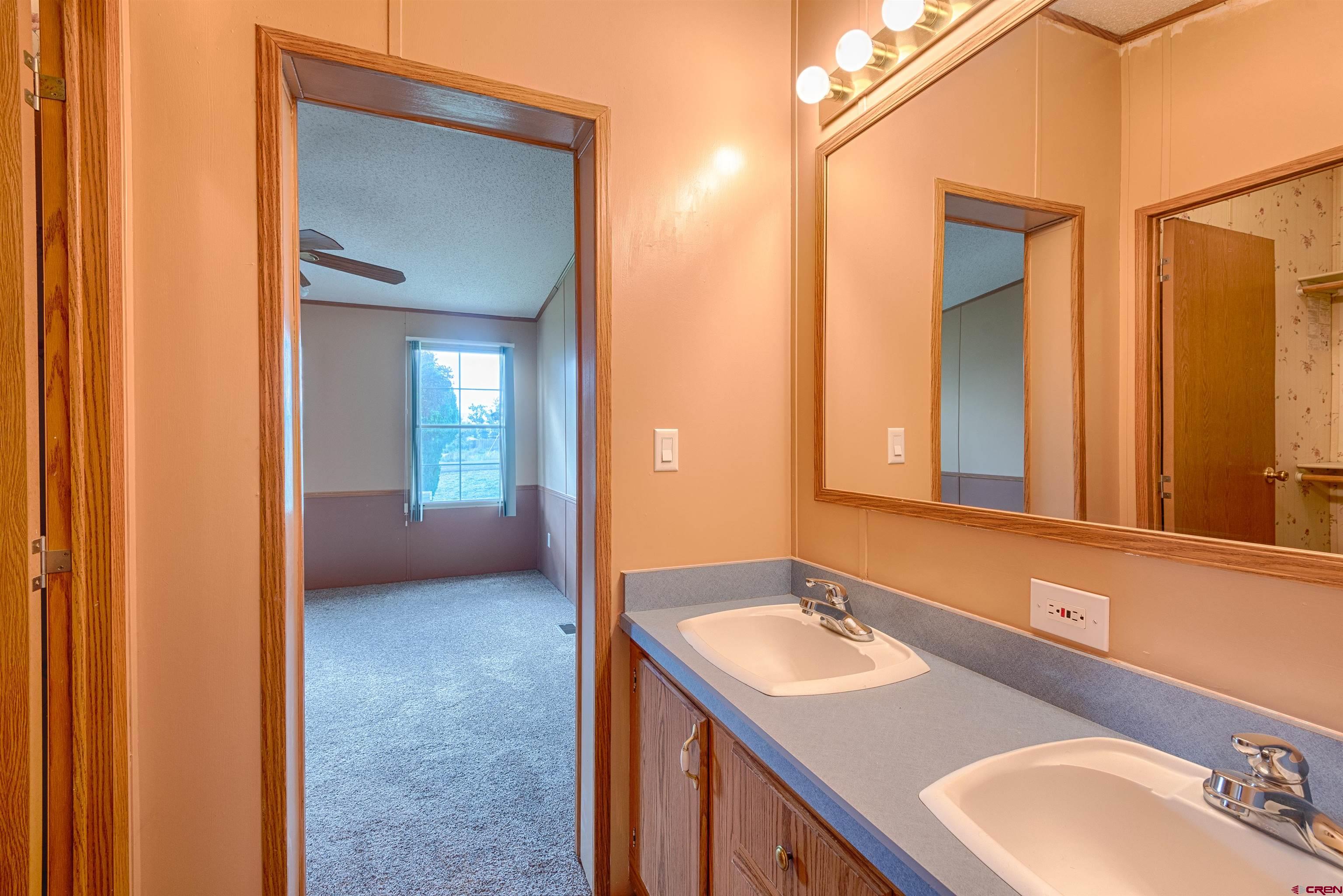 67135 N Road Montrose, CO 81401 - Photo 20 of 35 a bathroom with a sink and a mirror