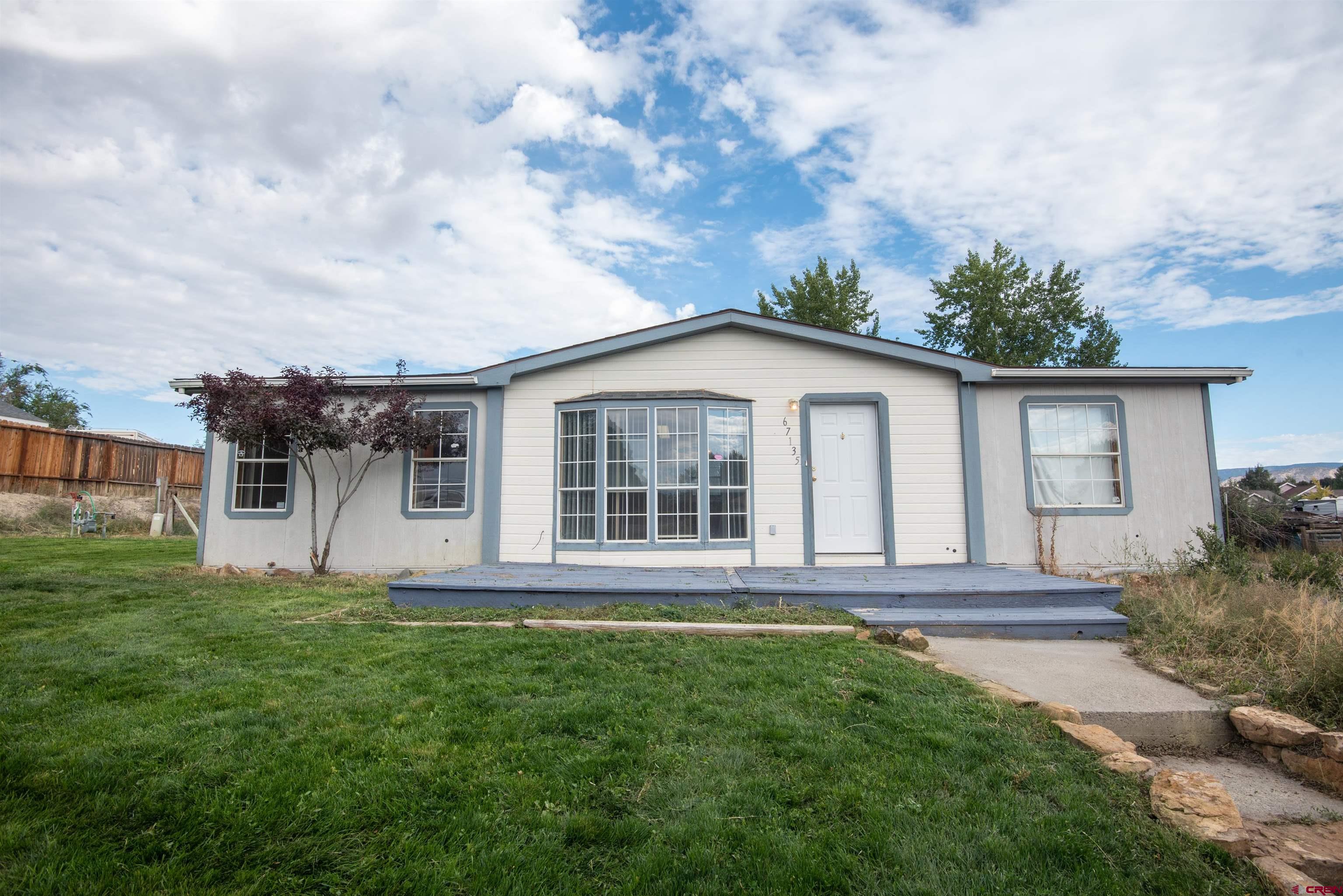 67135 N Road Montrose, CO 81401 - Photo 2 of 35 a view of a house with backyard and garden