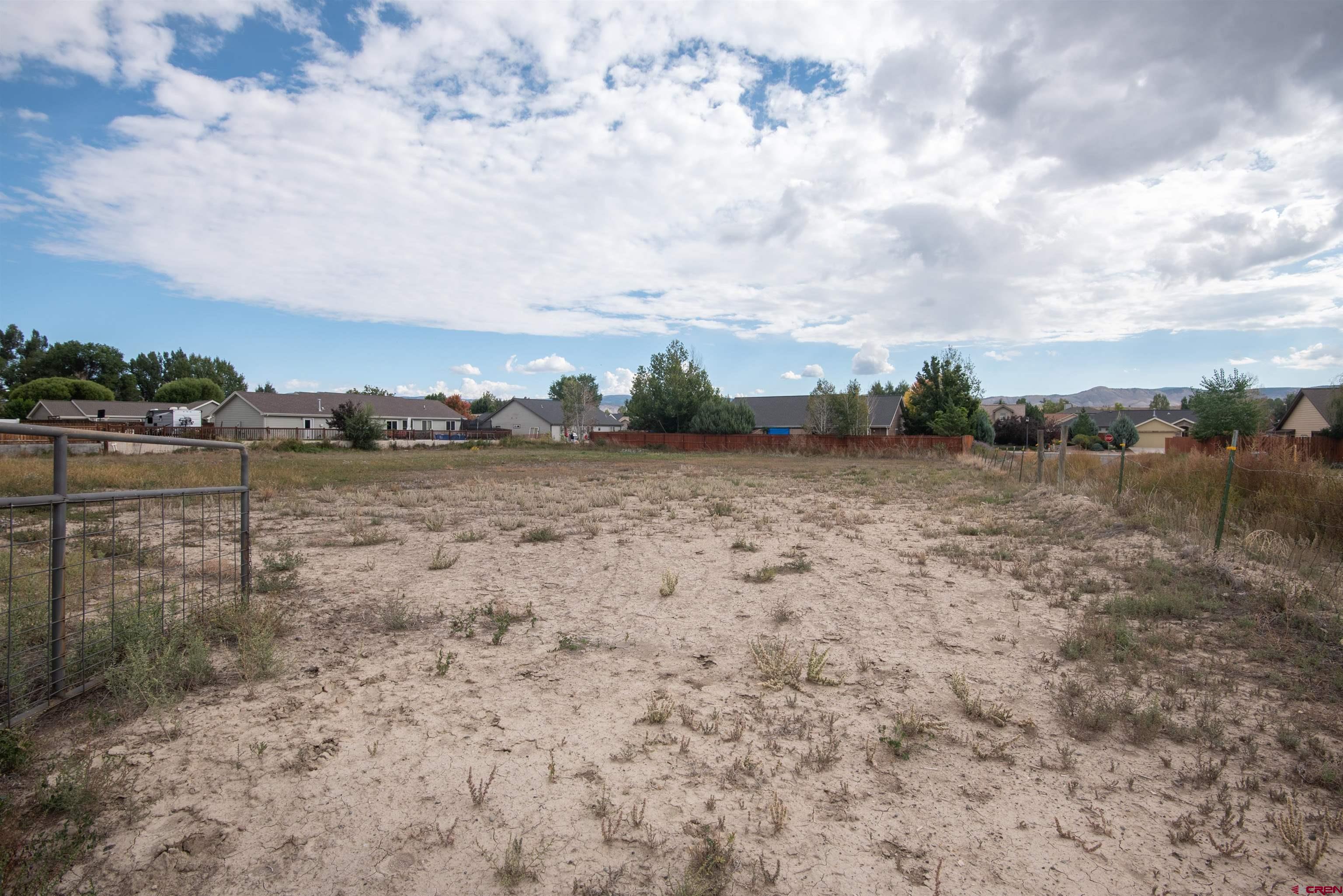 67135 N Road Montrose, CO 81401 - Photo 27 of 35 a view of a dry yard with wooden fence