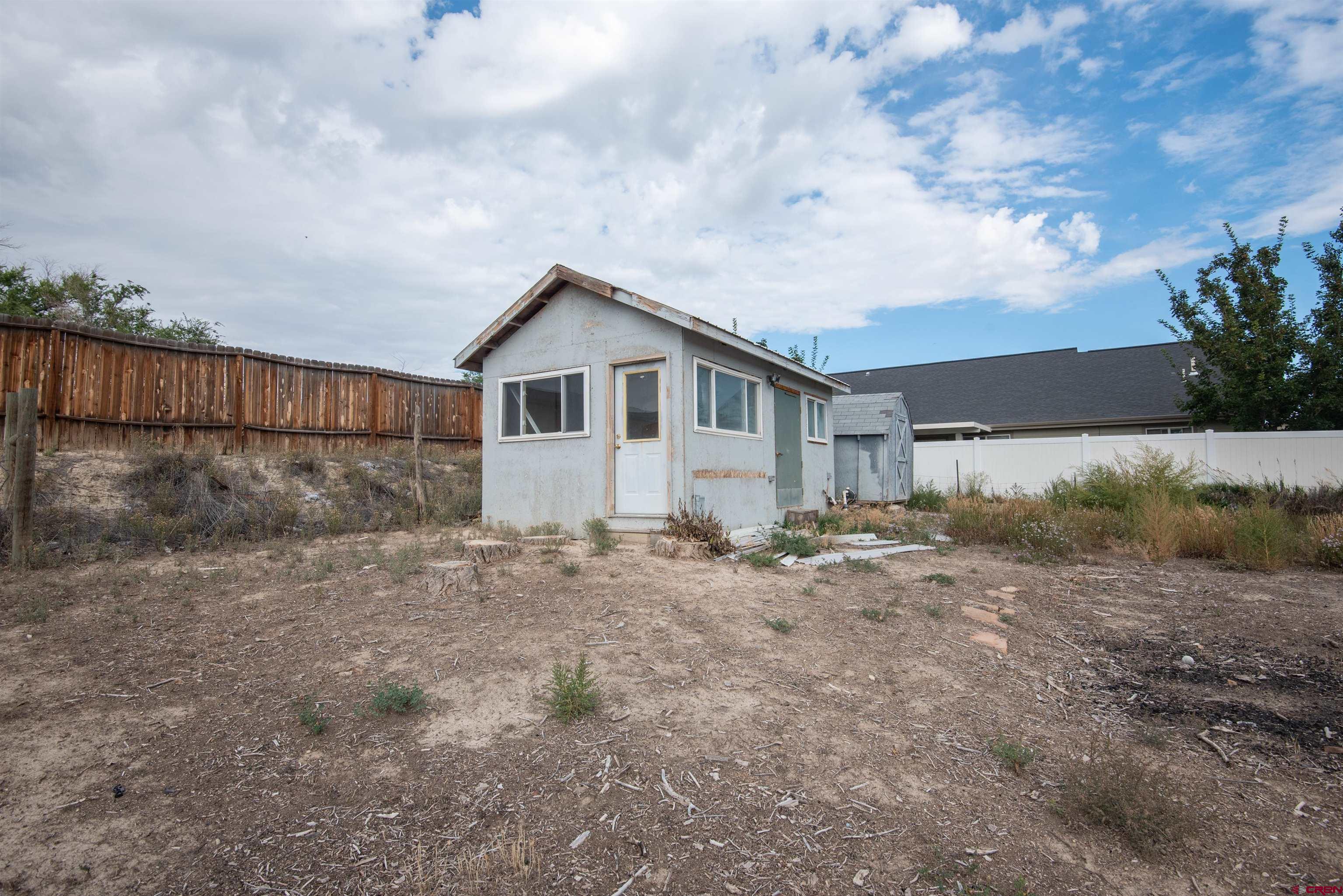 67135 N Road Montrose, CO 81401 - Photo 31 of 35 a view of a house with a dry yard and covered with trees