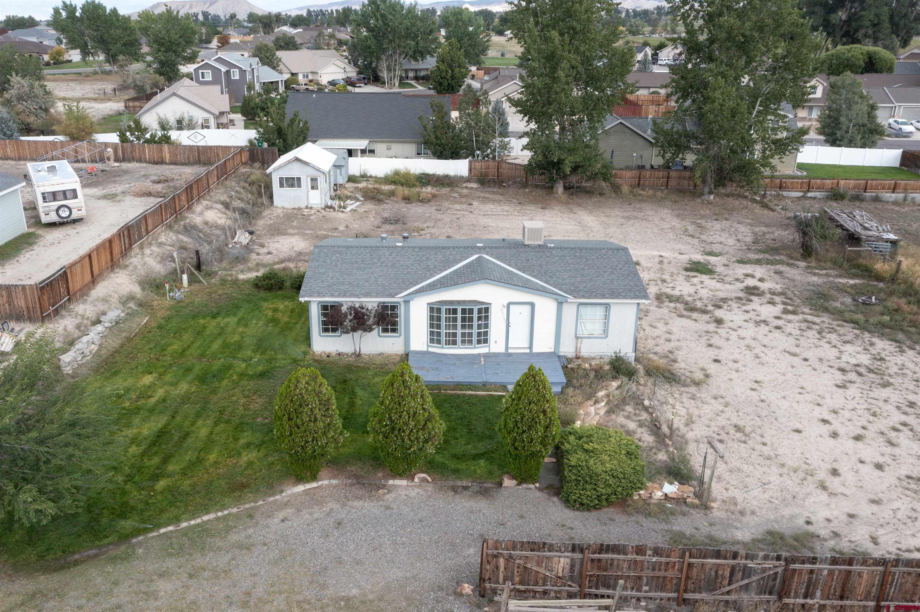 67135 N Road Montrose, CO 81401 - Photo 32 of 35 an aerial view of a house with a yard and lake view