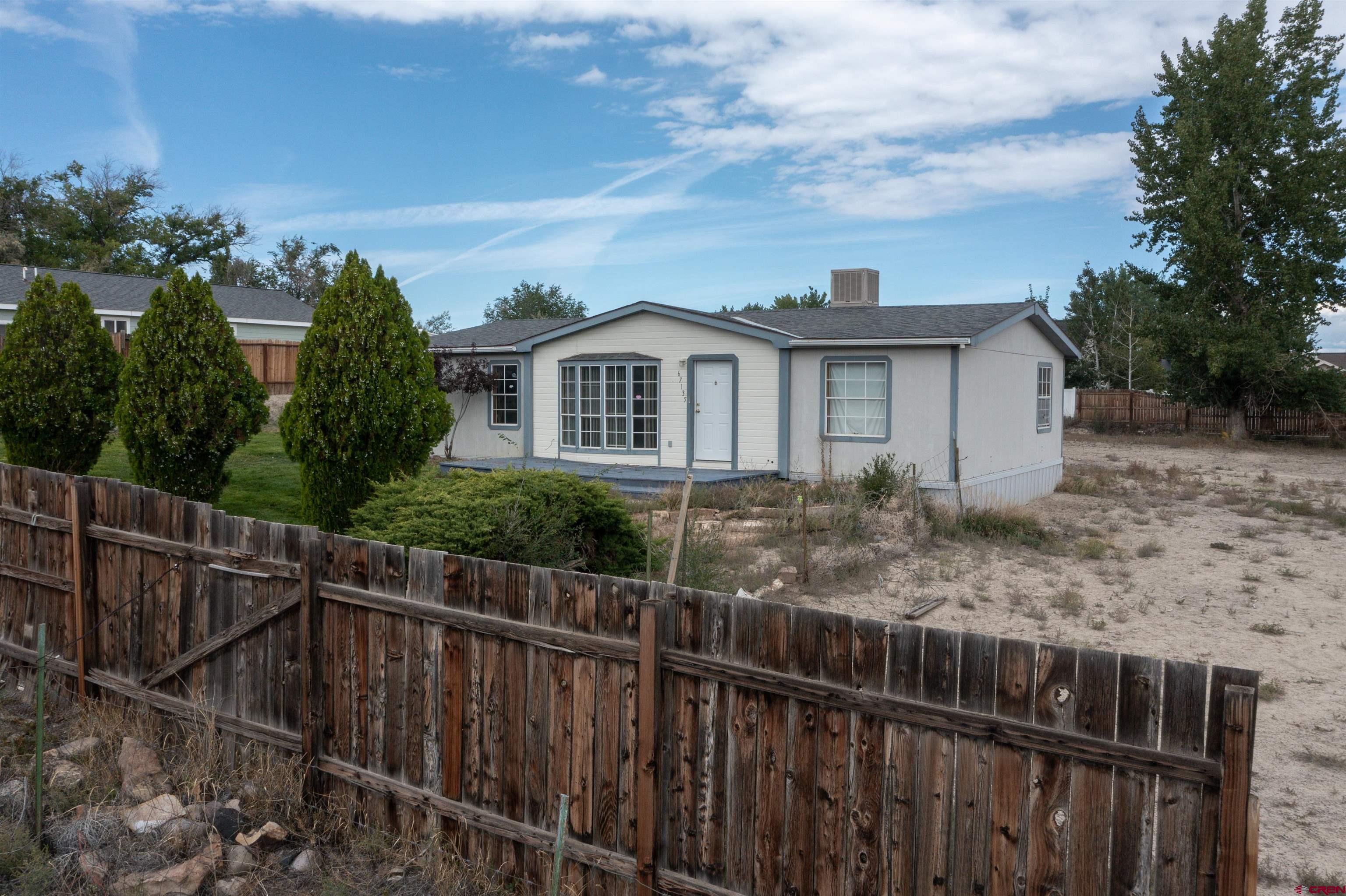 67135 N Road Montrose, CO 81401 - Photo 33 of 35 a view of a house with a wooden fence