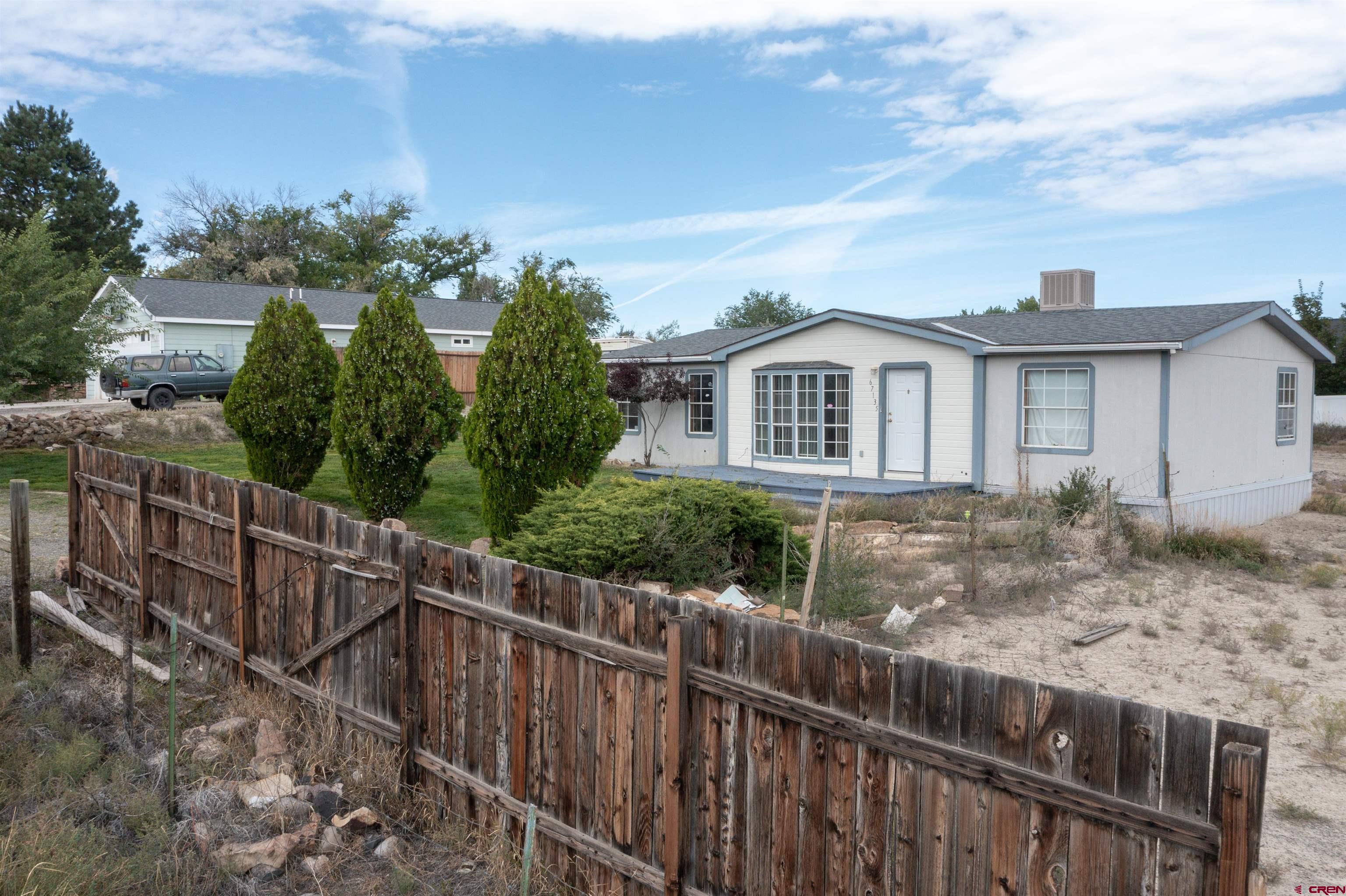 67135 N Road Montrose, CO 81401 - Photo 34 of 35 a view of a house with wooden fence