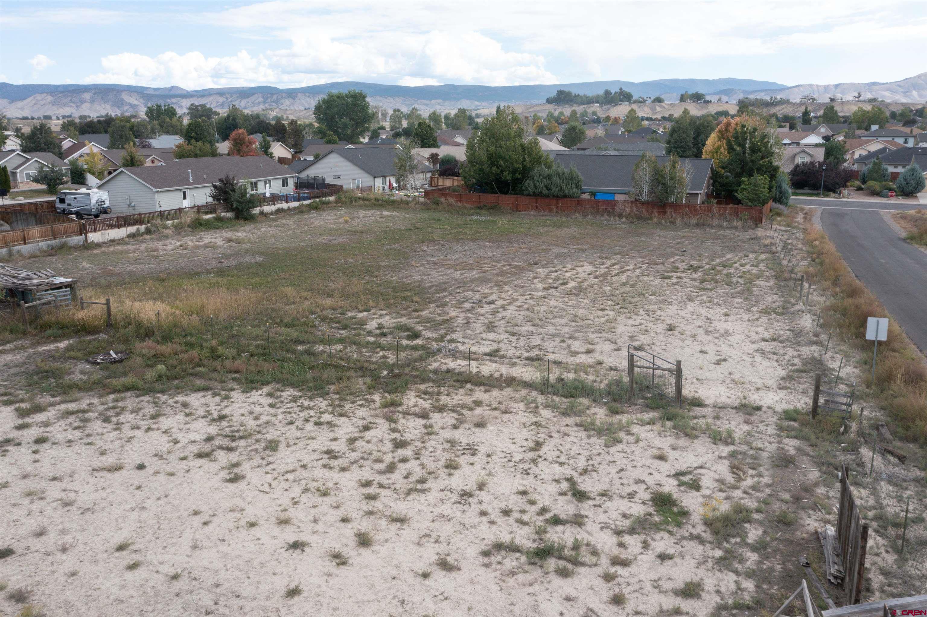 67135 N Road Montrose, CO 81401 - Photo 35 of 35 a view of a dry yard with mountains in the background