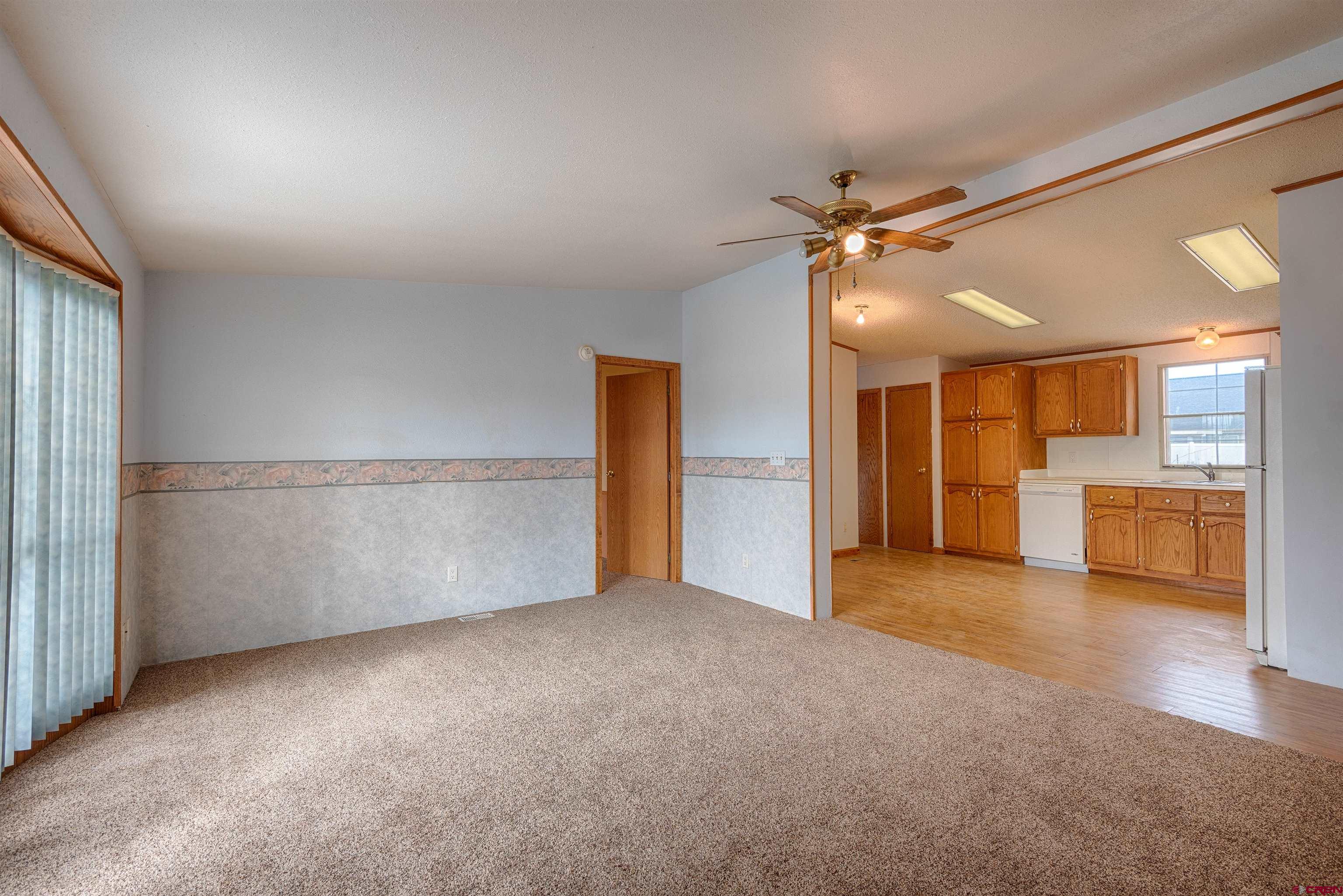 67135 N Road Montrose, CO 81401 - Photo 6 of 35 an empty room with a kitchen and a sink