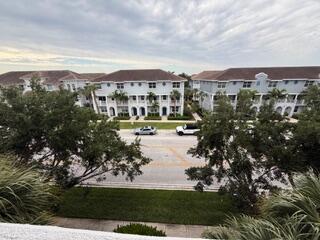 1660 Renaissance Commons Boulevard, Unit 2418 Boynton Beach, FL 33426 - Photo 15 of 18 a view of residential houses with a yard and lake view