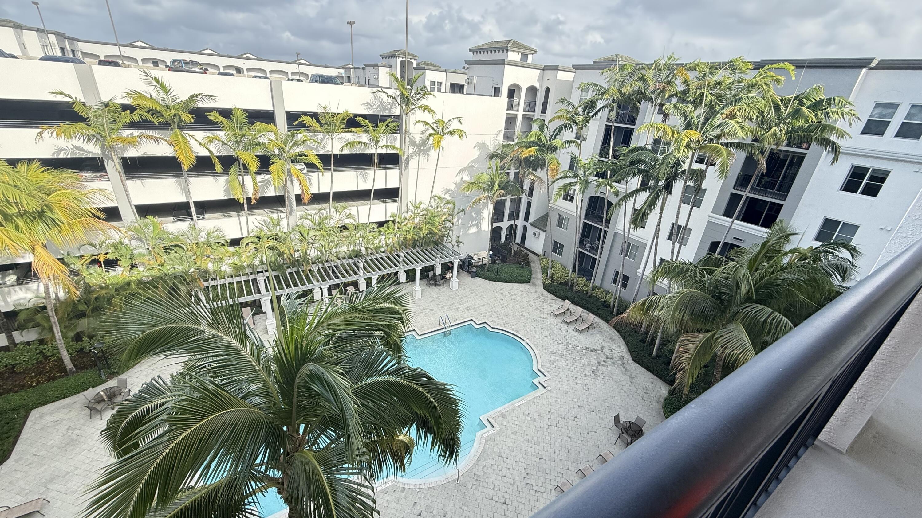 1660 Renaissance Commons Boulevard, Unit 2418 Boynton Beach, FL 33426 - Photo 3 of 18 a picture of a building with a garden