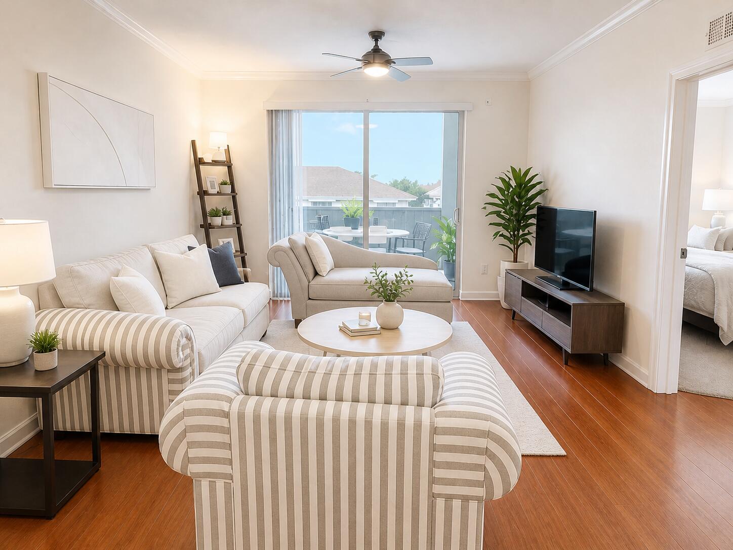 1660 Renaissance Commons Boulevard, Unit 2418 Boynton Beach, FL 33426 - Photo 6 of 18 a living room with furniture and a flat screen tv