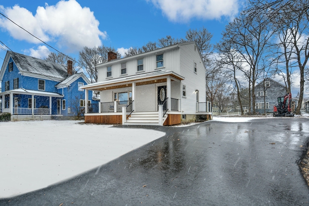 42 Riverside Avenue Concord, MA 01742 - Photo 20 of 21 a view of a white house with a large road and large trees