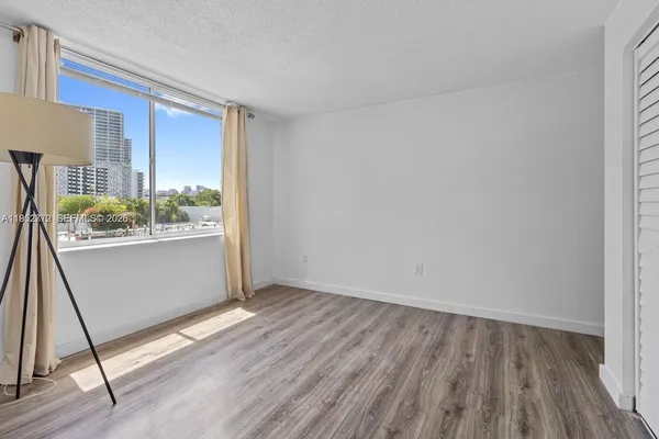 a view of an empty room and wooden floor