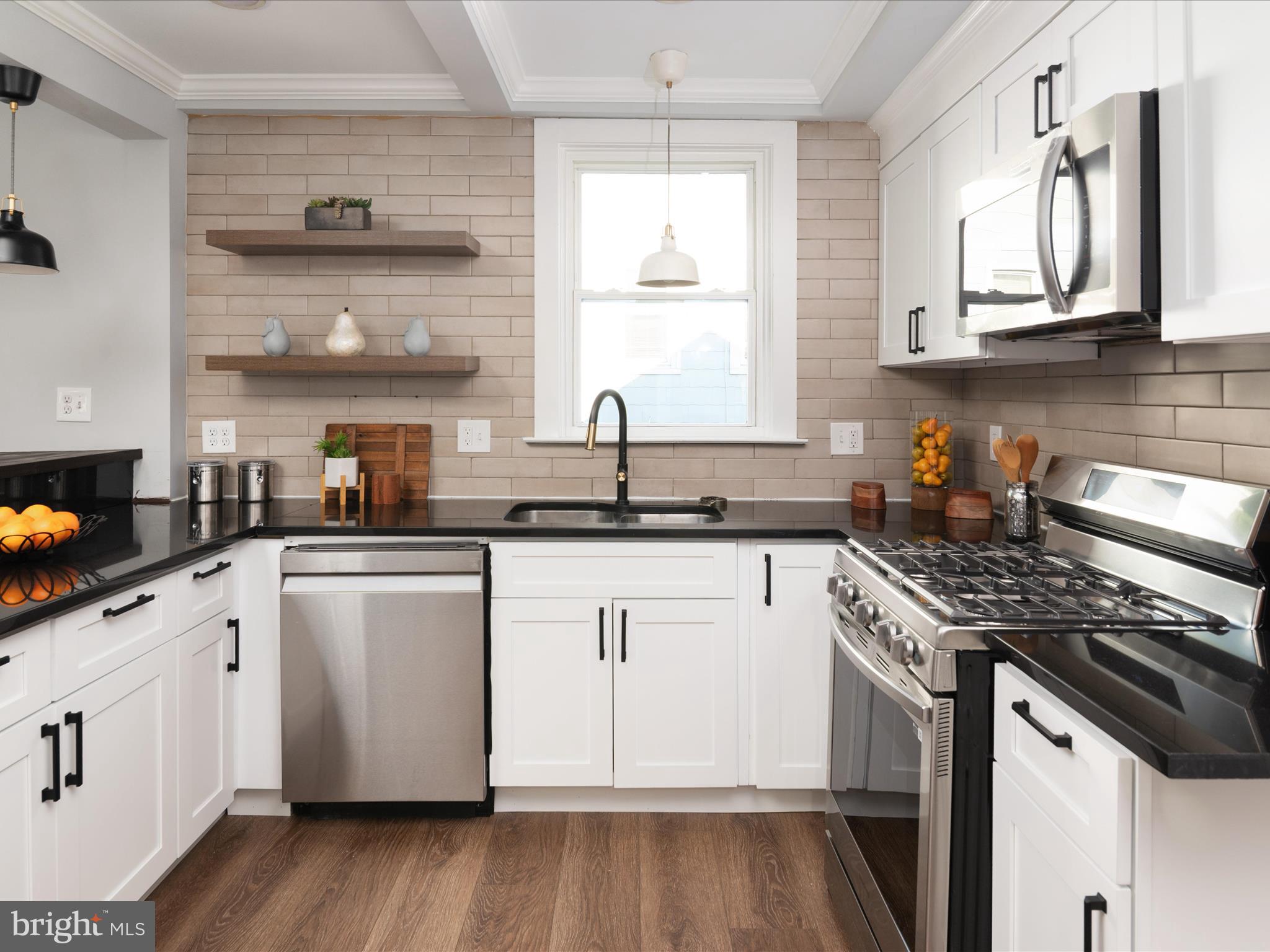 1119 Overbrook Road Baltimore, MD 21239 - Photo 14 of 72 a kitchen with stainless steel appliances granite countertop a sink stove and cabinets