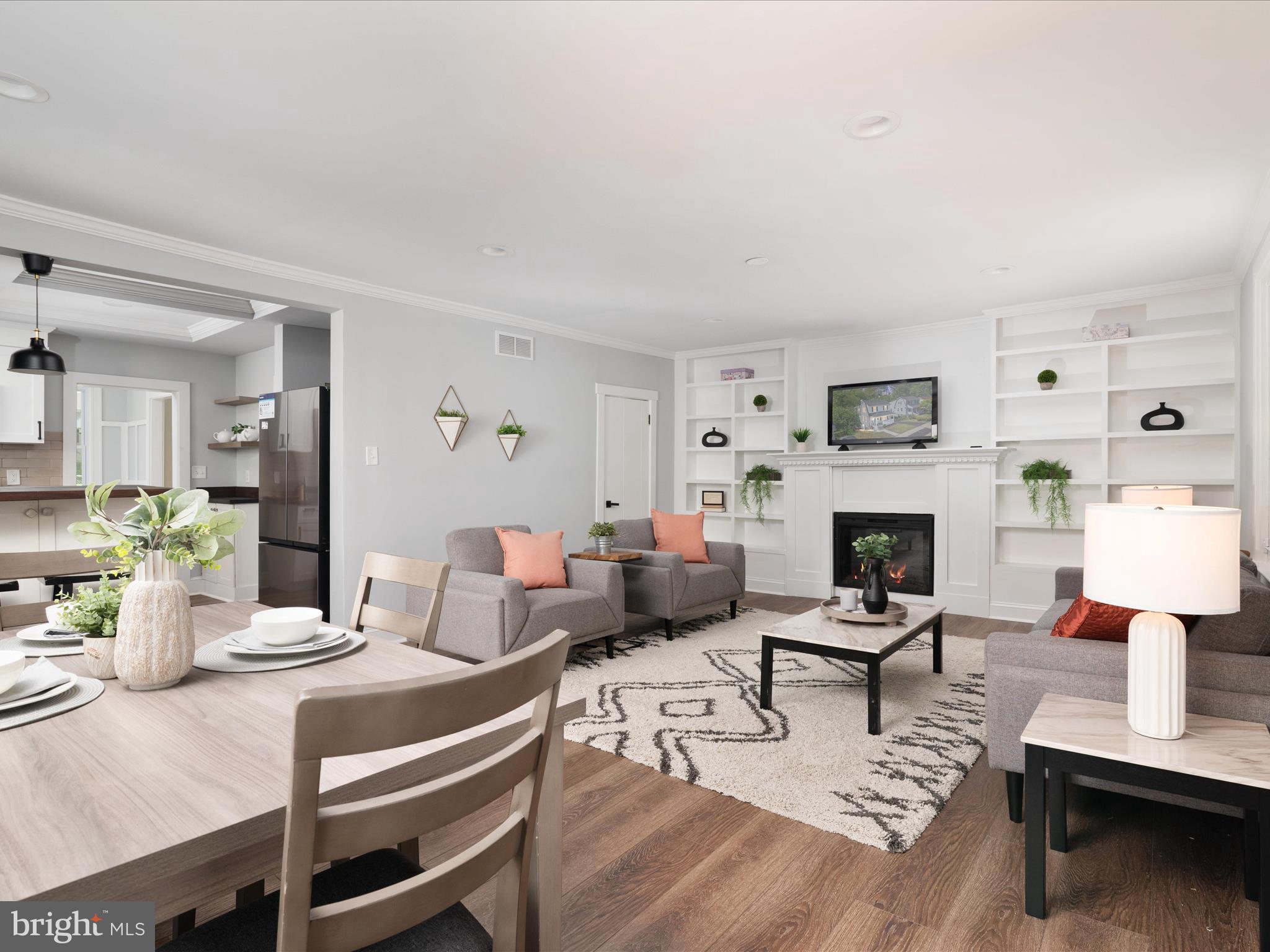 1119 Overbrook Road Baltimore, MD 21239 - Photo 18 of 72 a living room with furniture a fireplace and a table