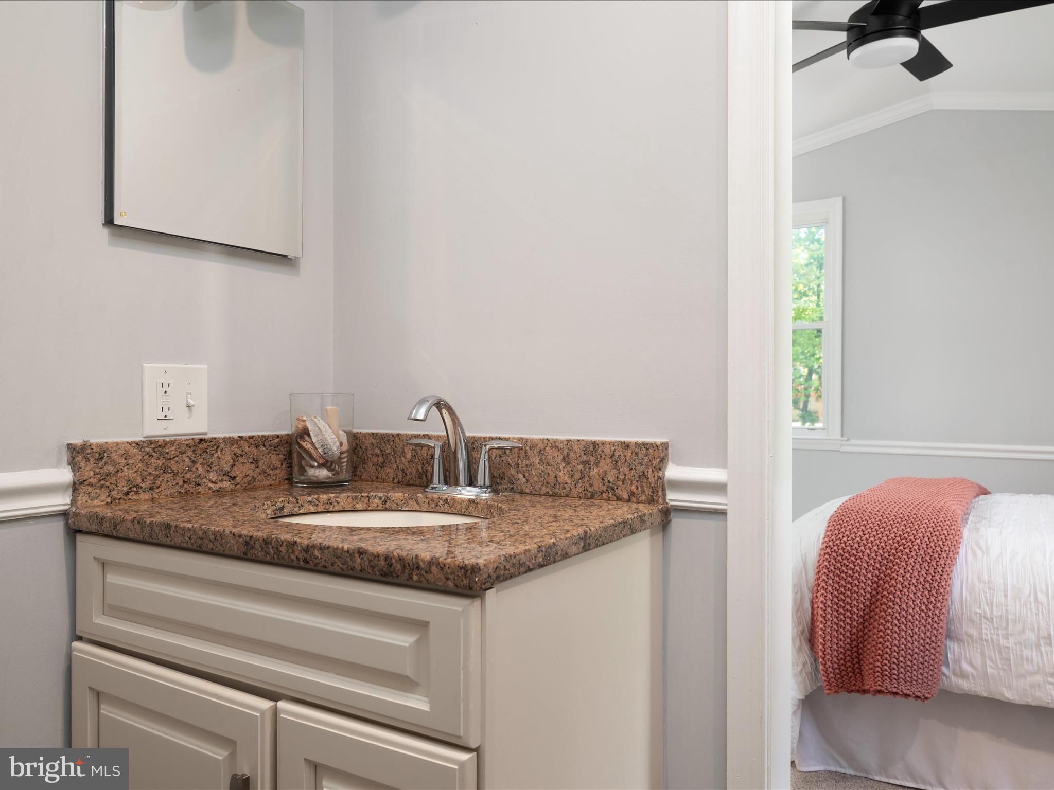 1119 Overbrook Road Baltimore, MD 21239 - Photo 36 of 72 a bathroom with a granite countertop sink and a mirror