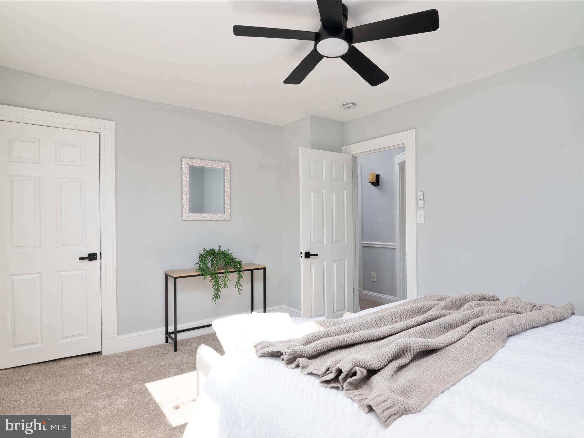 1119 Overbrook Road Baltimore, MD 21239 - Photo 45 of 72 a bedroom with a bed and a chandelier