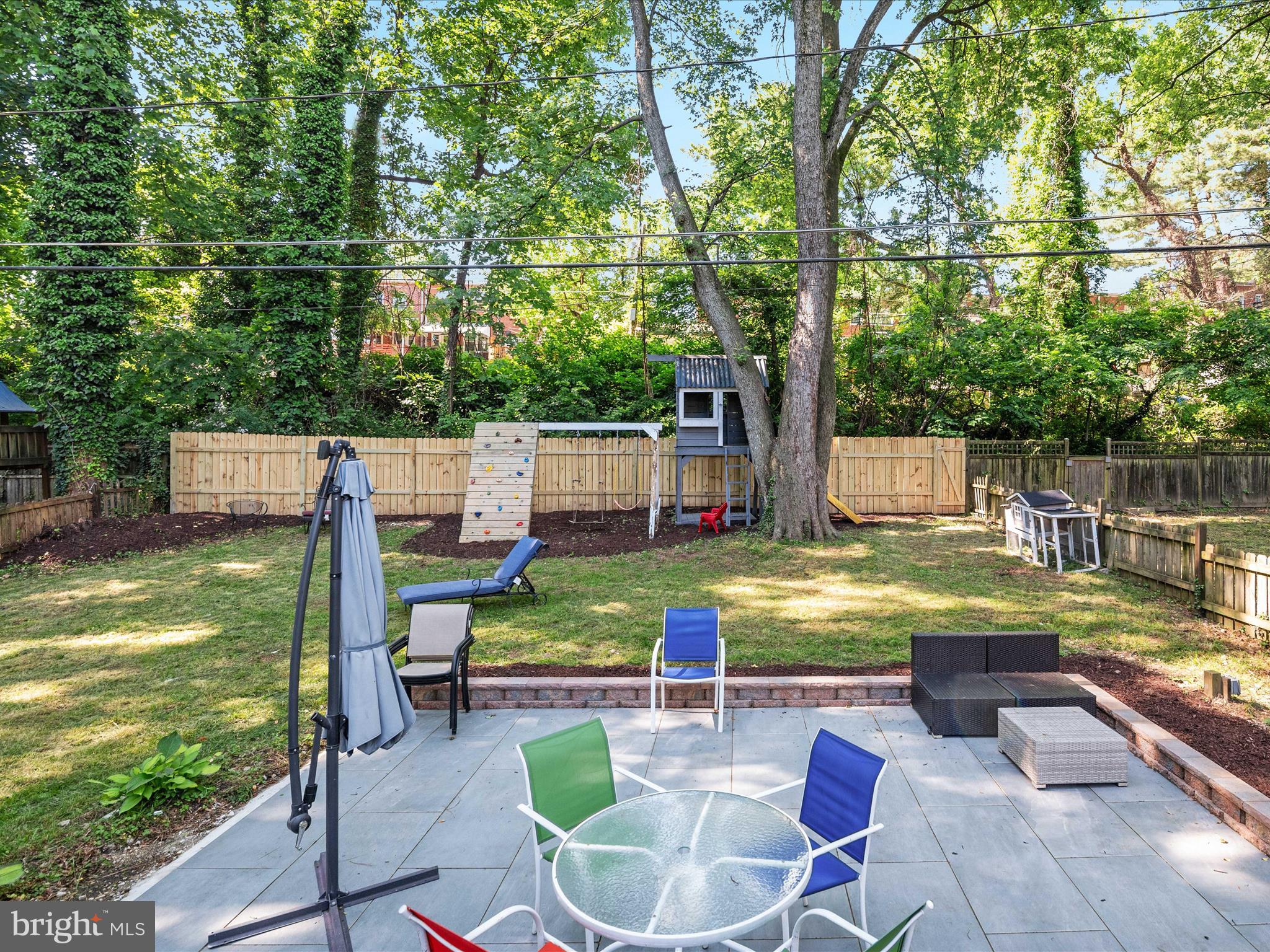 1119 Overbrook Road Baltimore, MD 21239 - Photo 54 of 72 a view of swimming pool with seating area and trees in the background