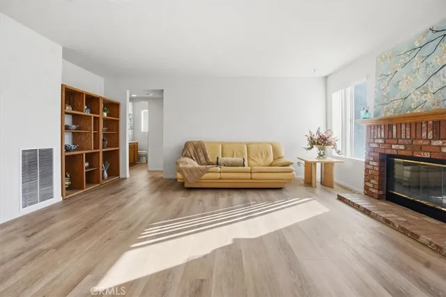a kitchen with stainless steel appliances granite countertop a stove cabinets and wooden floor
