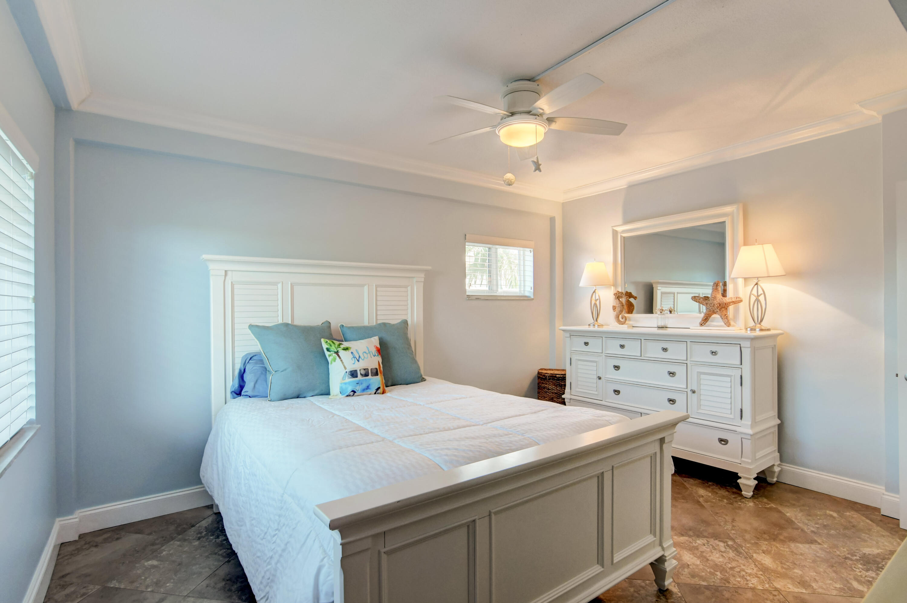 6520 North Ocean Boulevard, Unit 240 Ocean Ridge, FL 33435 - Photo 15 of 29 a bedroom with a bed and a dresser