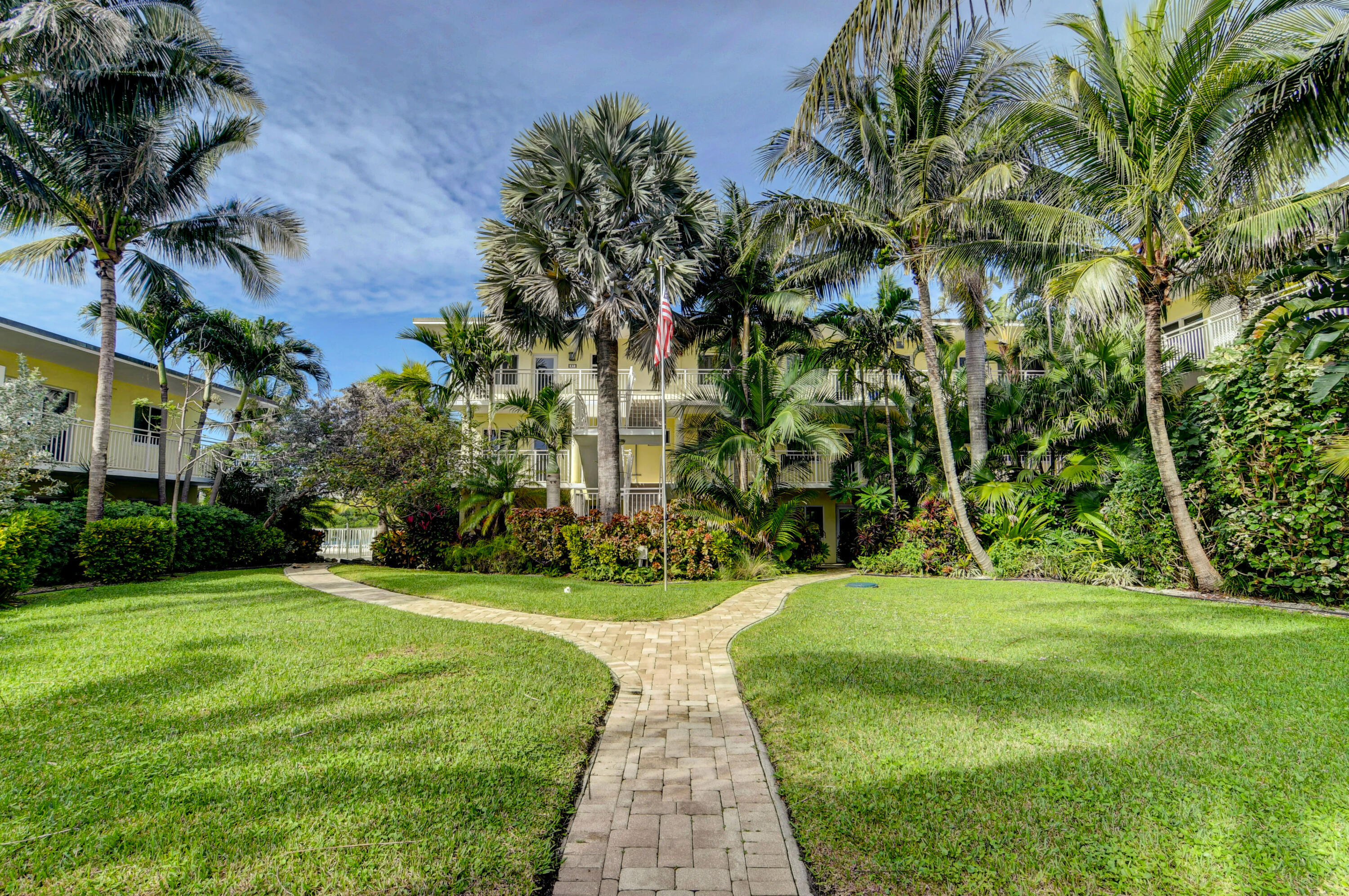 6520 North Ocean Boulevard, Unit 240 Ocean Ridge, FL 33435 - Photo 29 of 29 a view of a fountain in front of a house with a big yard