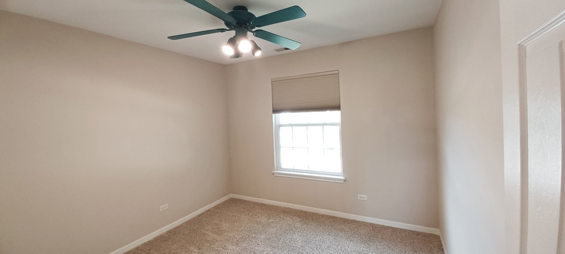 290 Crestview Drive, Unit C Wauconda, IL 60084 - Photo 19 of 19 an empty room with a window and a fan
