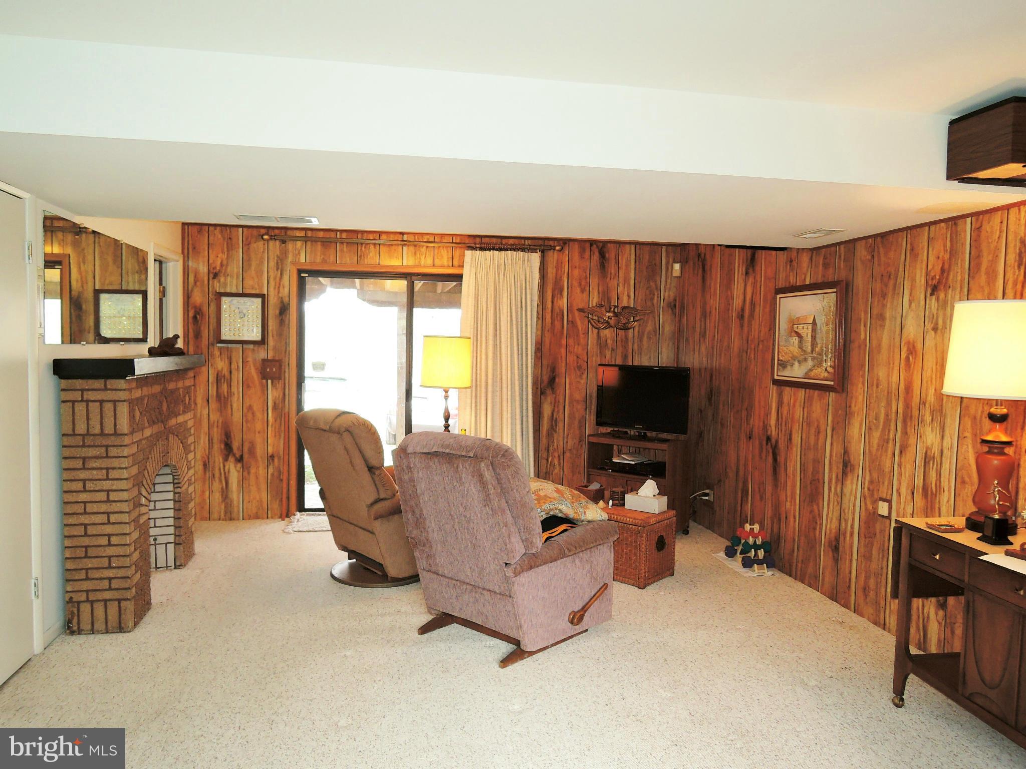 1010 Cold Bottom Road Sparks, MD 21152 - Photo 22 of 30 a living room with furniture a flat screen tv and a fireplace