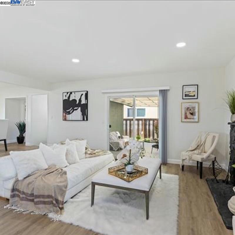 3184 Waugh Place Fremont, CA 94536 - Photo 14 of 47 a living room with furniture and wooden floor