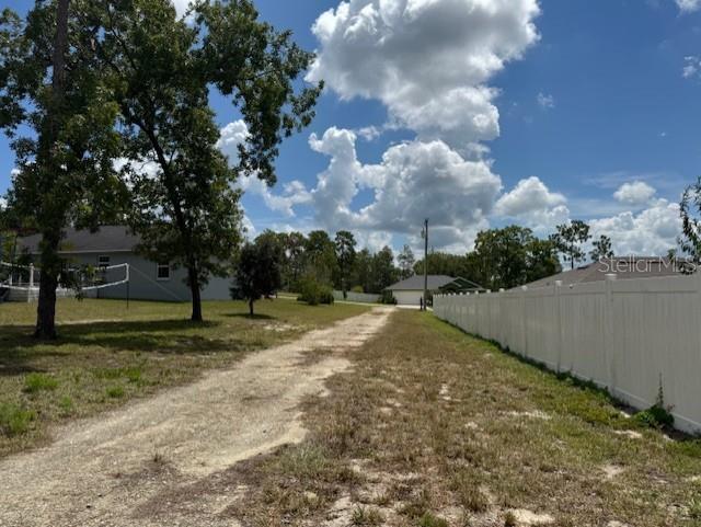 Tbd Southwest 109th Loop Ocala, FL 34476 - Photo 5 of 11 a view of a yard with yellow lighting