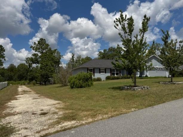 Tbd Southwest 109th Loop Ocala, FL 34476 - Photo 9 of 11 a view of a house with a yard and tree s