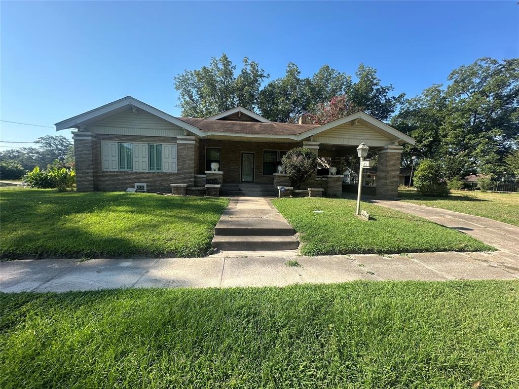 a front view of a house with yard patio and green space