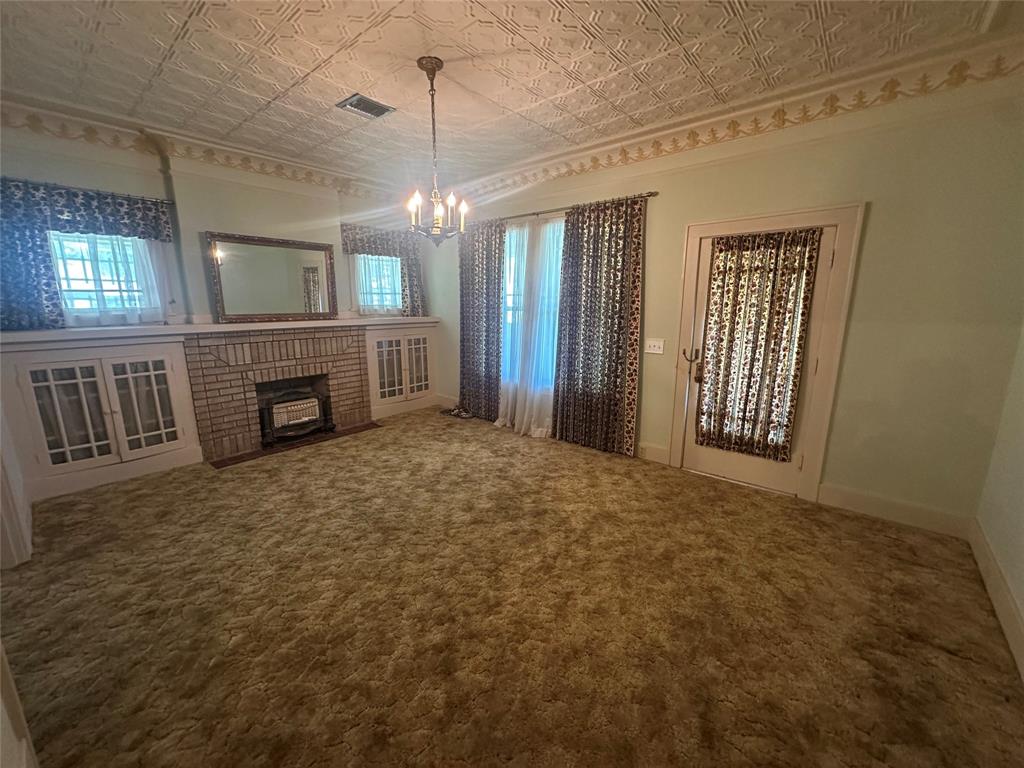2276 Main Street Haynesville, LA 71038 - Photo 19 of 22 an empty room with fireplace and windows