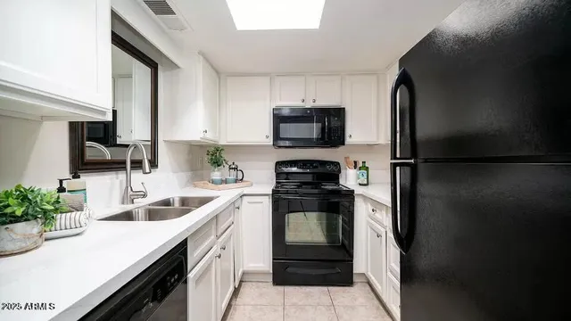 a kitchen with a sink and refrigerator