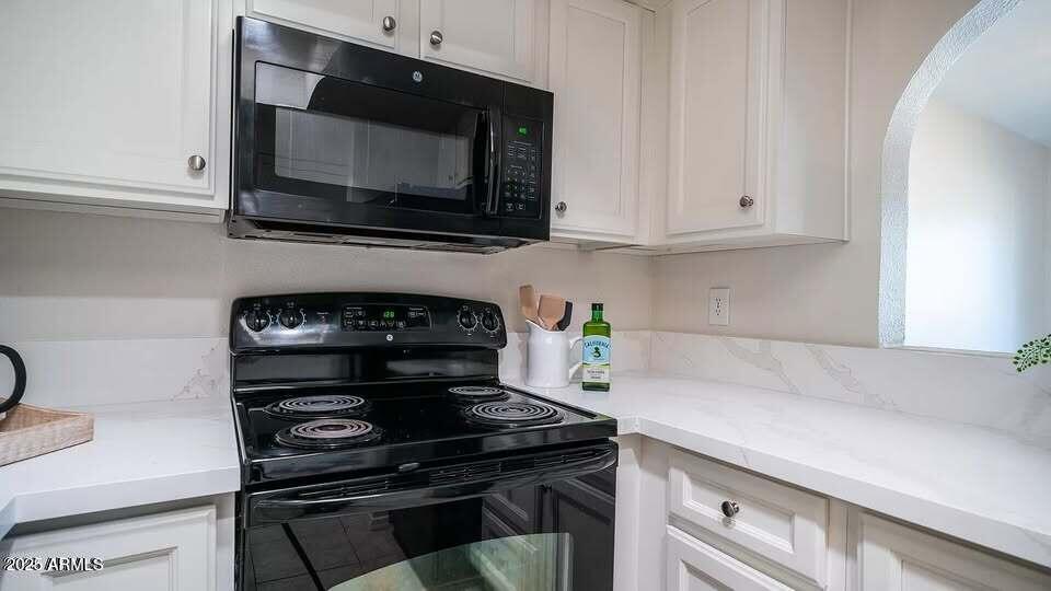 1329 South Mitchell Drive Tempe, AZ 85281 - Photo 5 of 21 a kitchen with a stove and a microwave