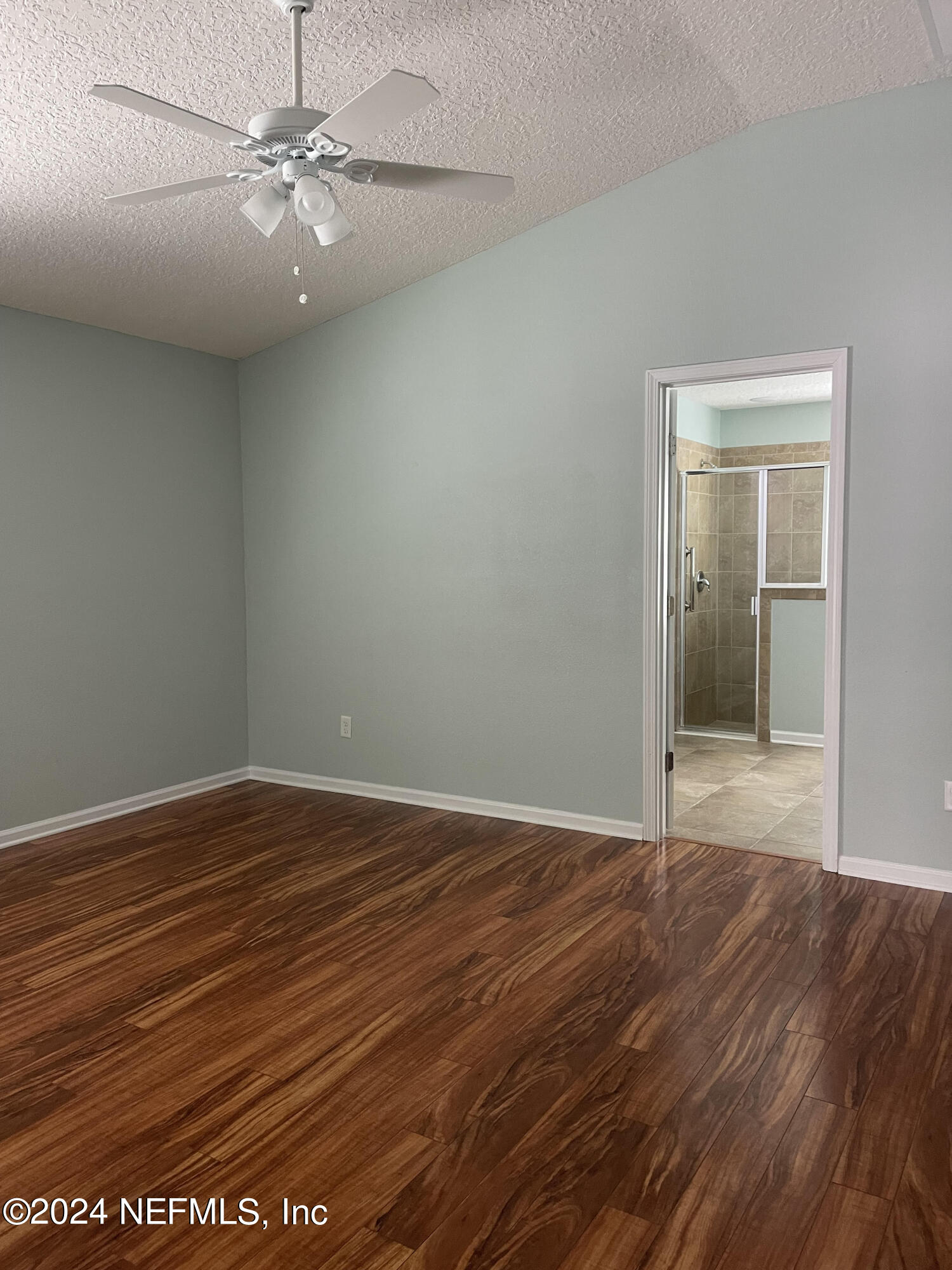 327 North Twin Maple Road St. Augustine, FL 32084 - Photo 5 of 9 an empty room with wooden floor fan and windows