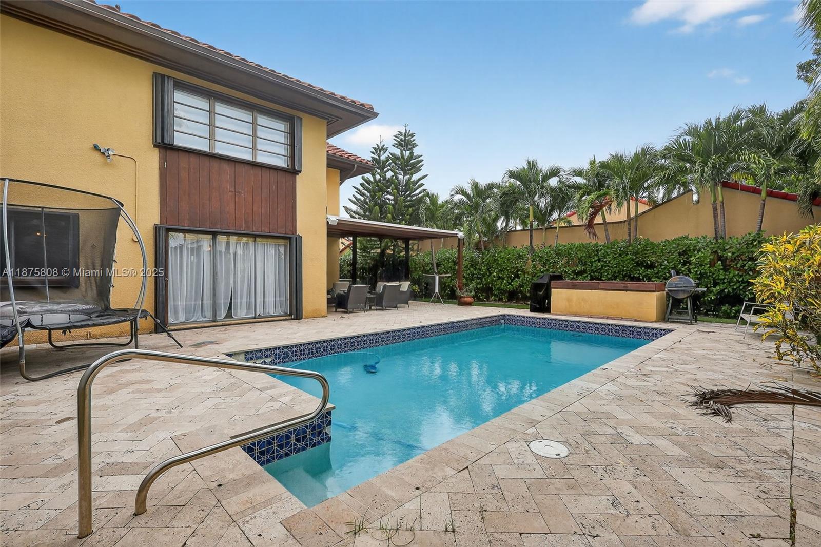a view of a house with swimming pool and sitting area