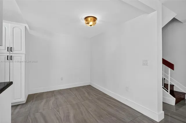 a dining room with furniture a chandelier and wooden floor