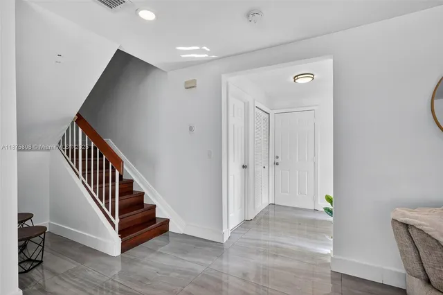 a kitchen with granite countertop white cabinets and stainless steel appliances