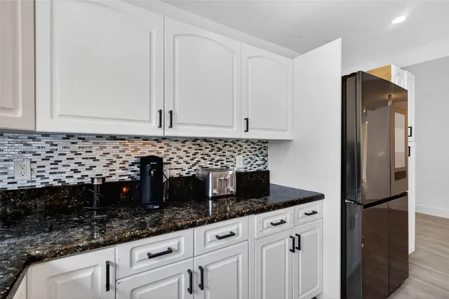 a kitchen with a sink stove and refrigerator