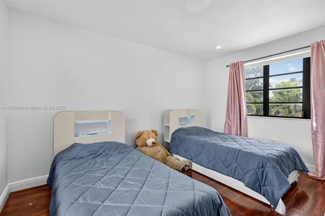 a bedroom with a bed and a television