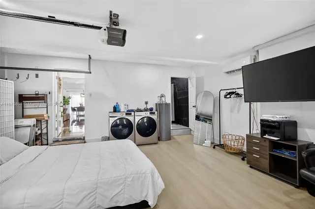 a bedroom with furniture a flat screen tv and a bed