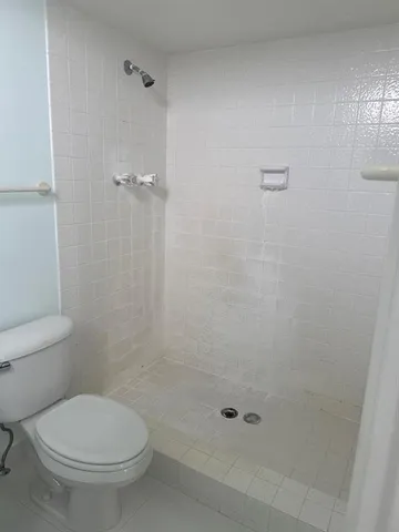 a bathroom with a toilet and a shower