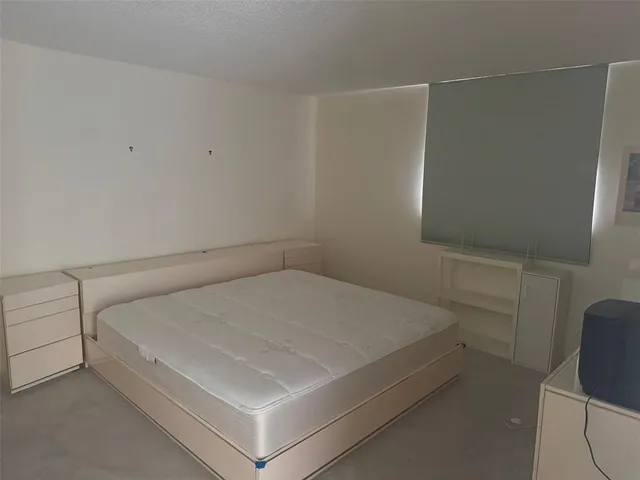 a bedroom with a bed and a chair