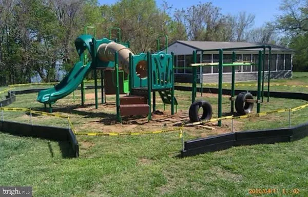 a view of a house with backyard swimming pool and sitting area