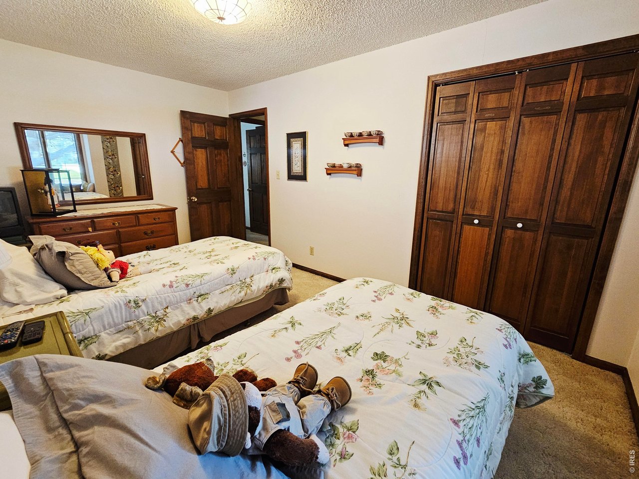 1010 Fairhurst Street Sterling, CO 80751 - Photo 22 of 36 a bedroom with bed and wooden floor