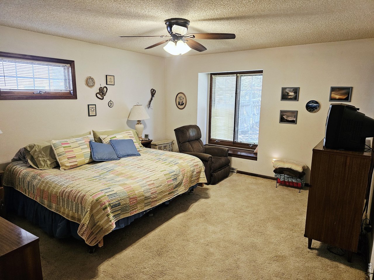 1010 Fairhurst Street Sterling, CO 80751 - Photo 23 of 36 a bedroom with bed and window with chair
