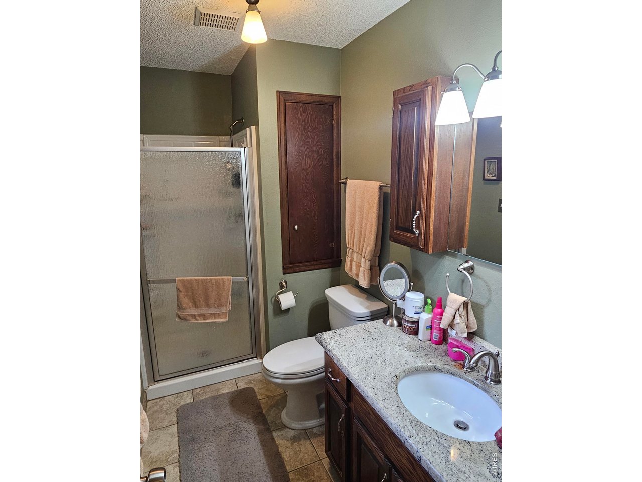 1010 Fairhurst Street Sterling, CO 80751 - Photo 26 of 36 a bathroom with a granite countertop sink toilet and shower